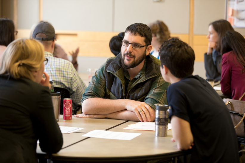 Graduate Student Eugene Law leads a small group discussion about mentoring strategies