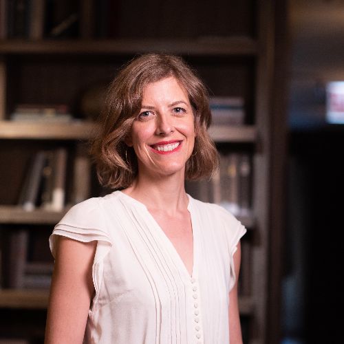 Erin Furtak, University of Colorado at Boulder, smiling in front of bookshelves