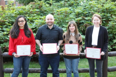 Four awardees outside with certificates