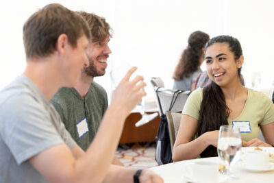 Julien, Imanol, and Beatriz in discussion at a lunch