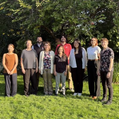9 postdocs lined up outdoors in the evening