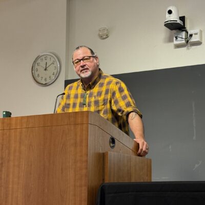 Sweeney Windchief speaks from behind a podium during the November 2025 MAC mentoring keynote